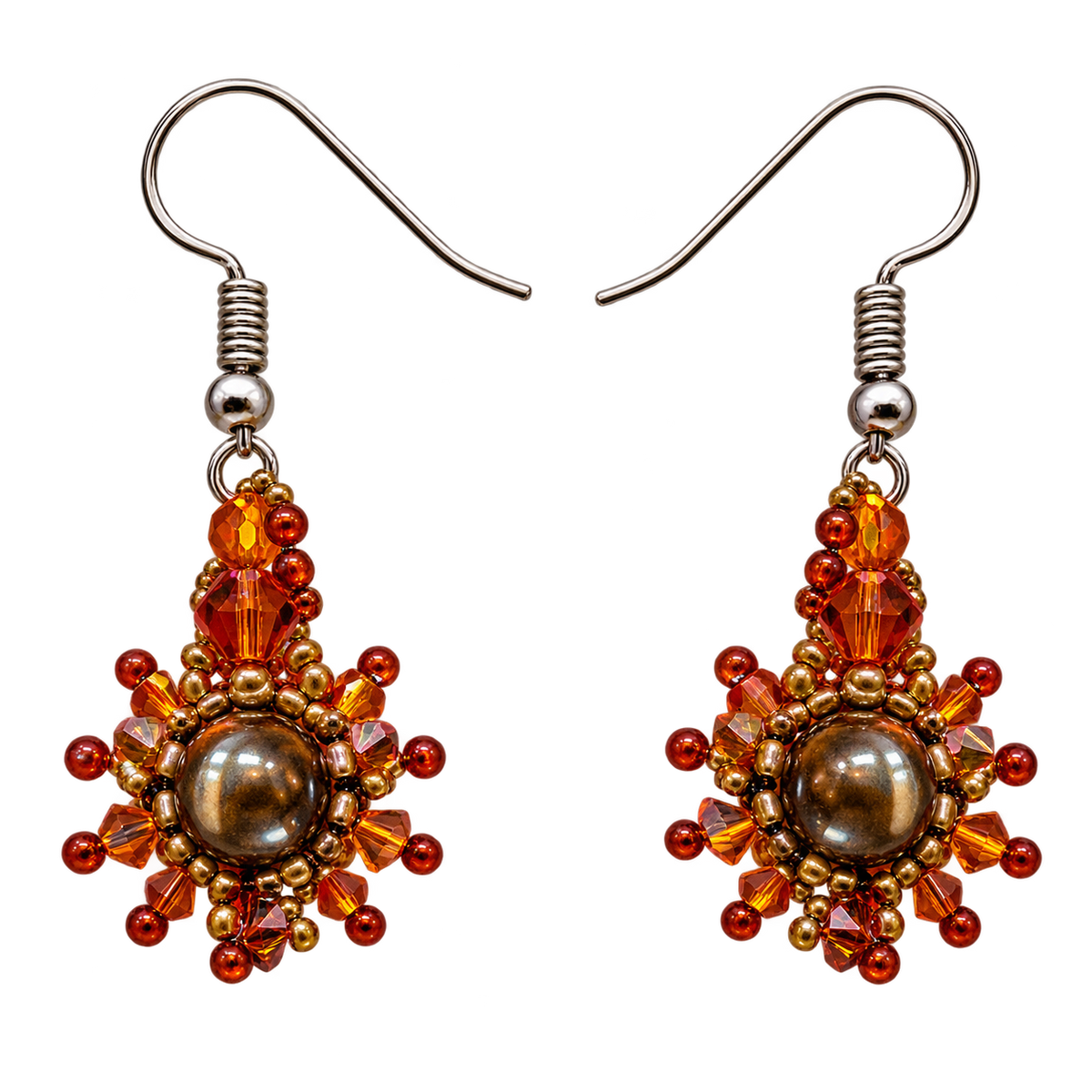 A pair of handmade beaded drop earrings with silver-tone fishhook wires. The earrings feature a central round brown pearl-like bead surrounded by faceted amber, orange, and red beads, with small gold-toned spacer beads.