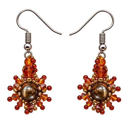 A pair of handmade beaded drop earrings with silver-tone fishhook wires. The earrings feature a central round brown pearl-like bead surrounded by faceted amber, orange, and red beads, with small gold-toned spacer beads.