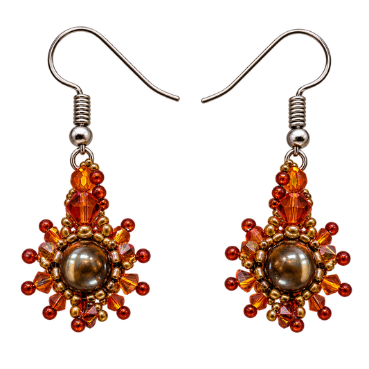 A pair of handmade beaded drop earrings with silver-tone fishhook wires. The earrings feature a central round brown pearl-like bead surrounded by faceted amber, orange, and red beads, with small gold-toned spacer beads.