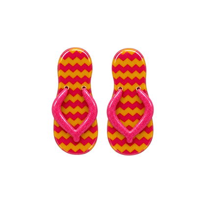 A pair of flip-flop sandals with a bright pink glittery strap and a yellow and pink chevron patterned sole.